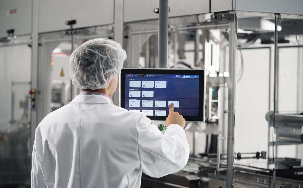 Bosch industry 4.0 operator using touchscreen in factory 1