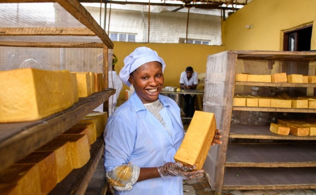 A baker holds a loaf of orange fleshed sweet potato bread in her bakery in nnewi